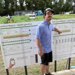 Ben Sherk, regional account manager at ATP Nutrition in southern Manitoba, points at a chart during a presentation at ATP’s booth at Ag in Motion 2025, near Langham, Sask.