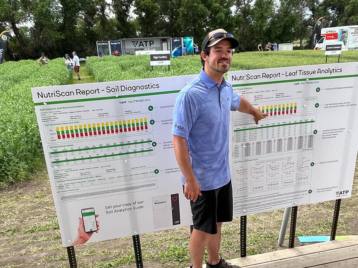 Ben Sherk, regional account manager at ATP Nutrition in southern Manitoba, points at a chart during a presentation at ATP’s booth at Ag in Motion 2025, near Langham, Sask.