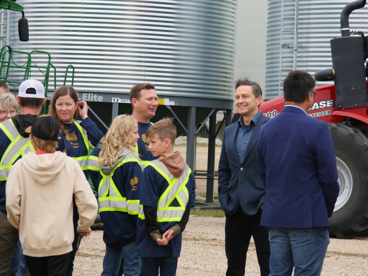 Pierre Poilievere at Sixteen Grains near Saskatoon, Sask. speaking to one of the farm owners.
