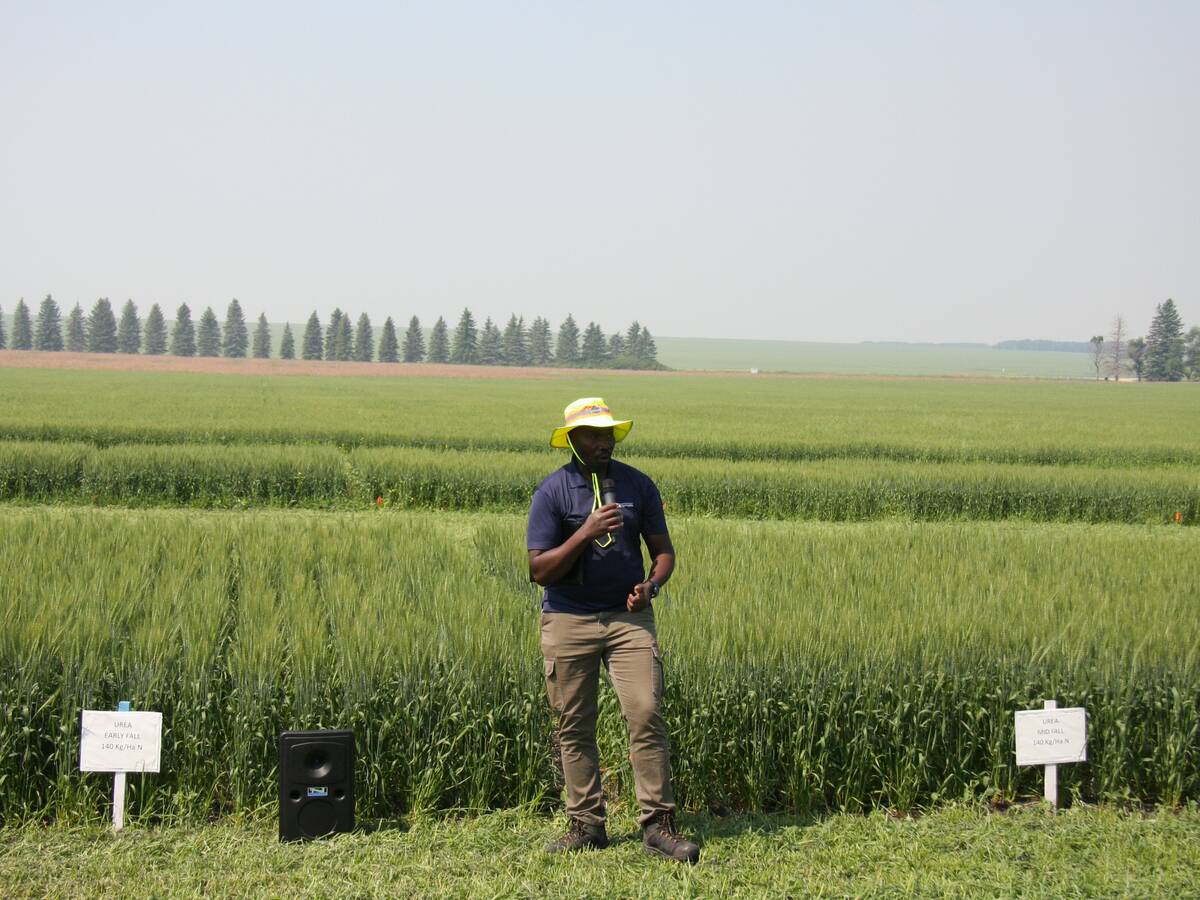 Patrick Mooleki, Agriculture and Agri-Food Canada research scientist, speaks about nitrogen research in front of barley plots in Melfort, Sask.