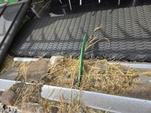 Rocks sit in a device called a "rock dam" installed on the header of a combine to prevent rocks from entering the machine and causing damage.