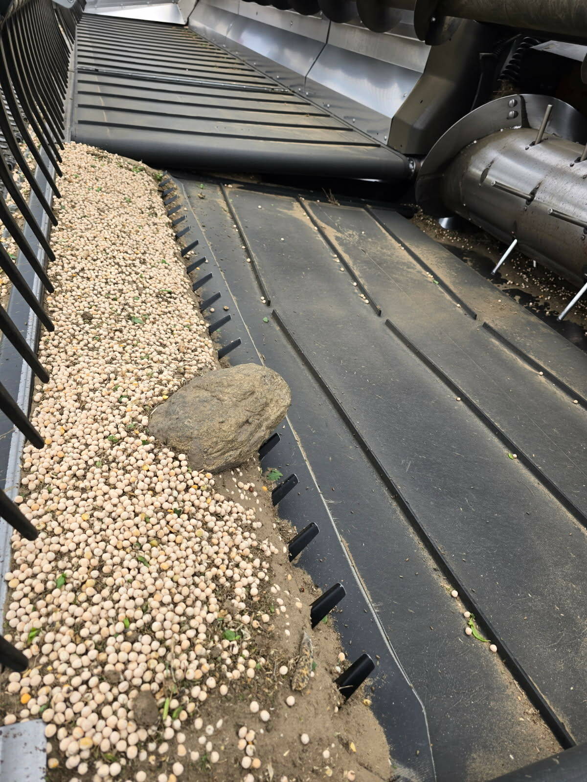 A rock sits in a rock dam, a device invented by two brothers to prevent rocks from entering a combine and causing damage.