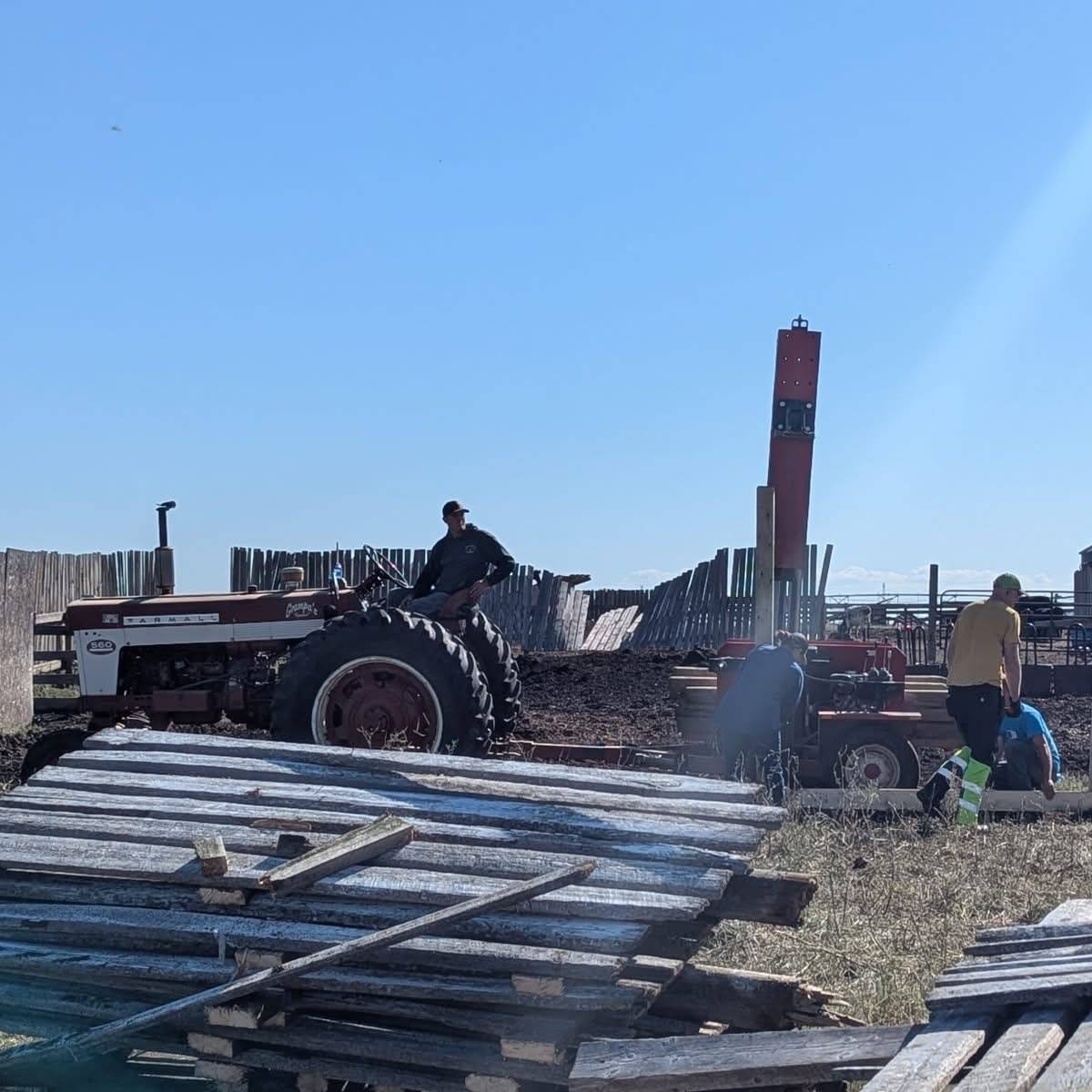 Volunteers work to clean up downed corral fencing at the White Barn Fun Farm.