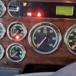 Close-up of the dash of a diesel truck showing a number of warning lights on.