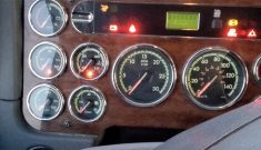 Close-up of the dash of a diesel truck showing a number of warning lights on.