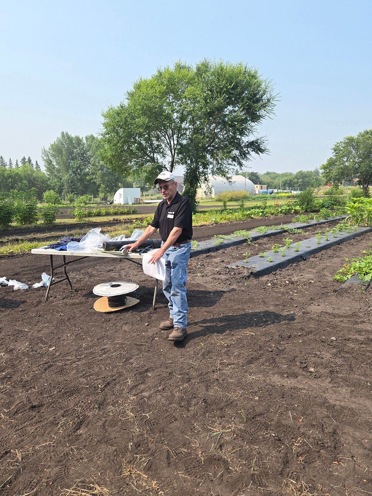 Tom Gonsalves stands in front of some plants in a plot as he discusses drip tape and plastic mulch at Assiniboine College’s Horticulture School 2025 in Brandon July 31.
