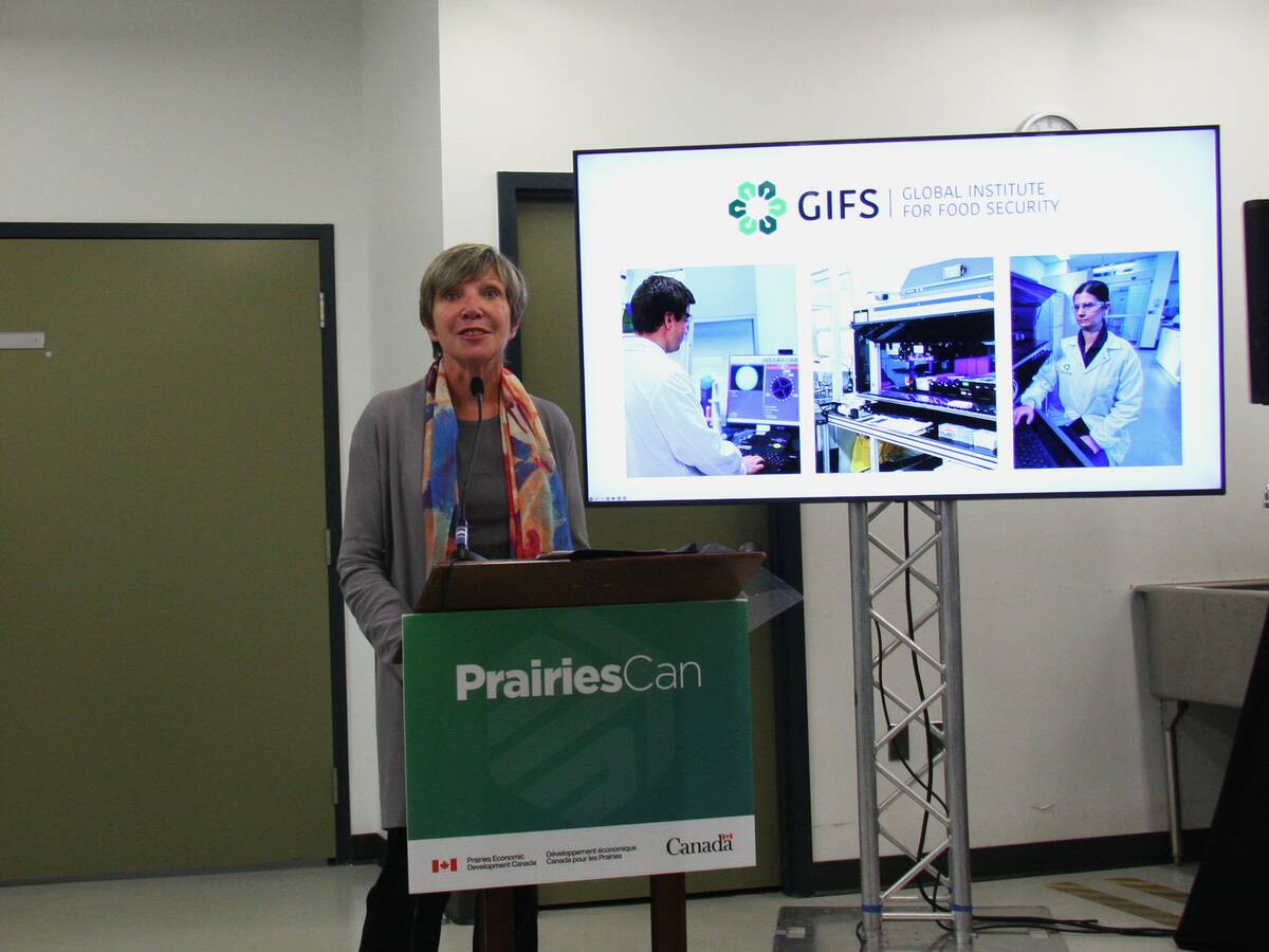 Minister Eleanor Olszewski stands at a lectern at the Global Institute for Food Security during a funding announcement.