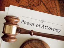 A stock image of a "Power of Attorney" document with a judge's gavel on top of it.