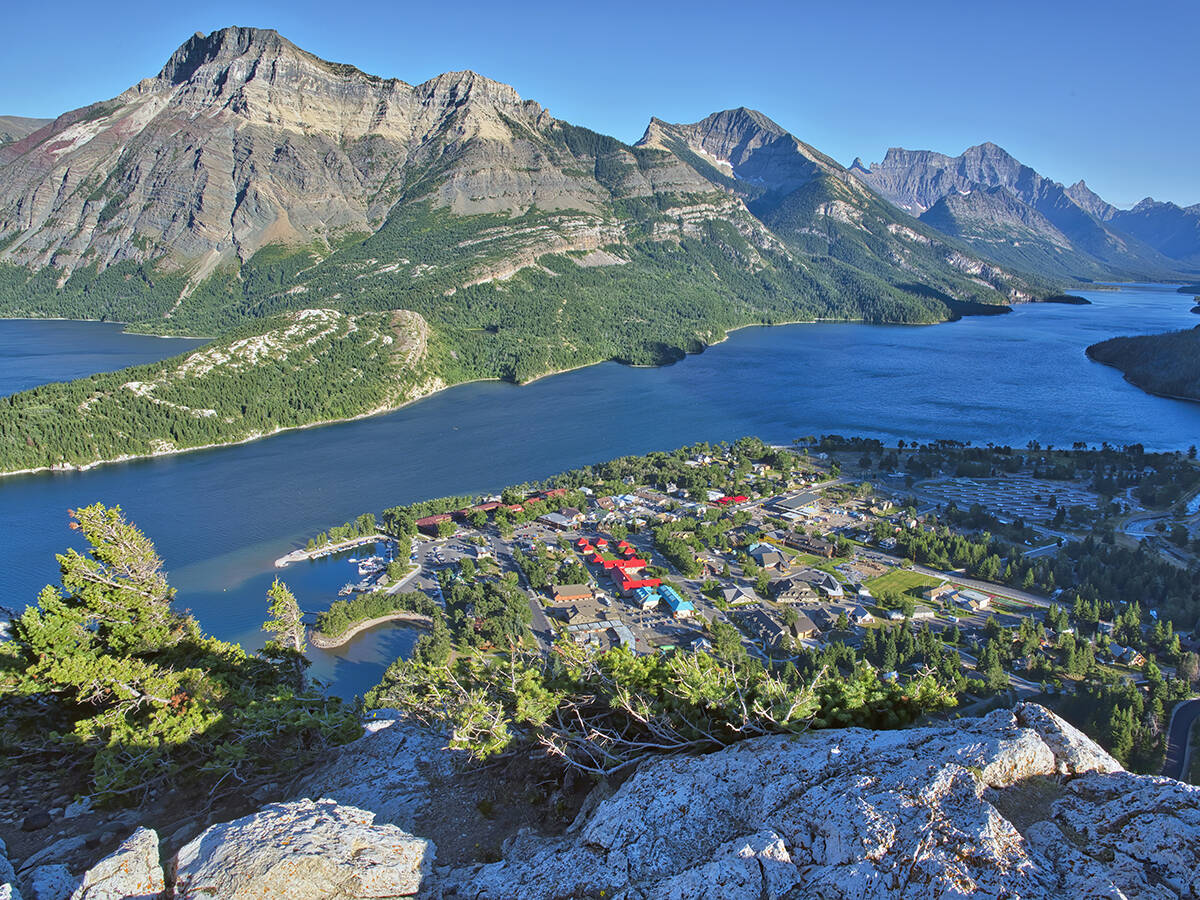 Waterton townsite and Upper Waterton Lake as seen from high up on a nearby mountain.