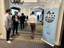 Delegates mingle in the doorway of a large meeting room with a large "PSCC logo" and sign on the door at the annual Pulse & Special Crops Convention in Whistler, B.C., in September 2025.