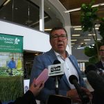 Saskatchewan Premier Scott Moe takes questions from reporters in Saskatoon International Airport.
