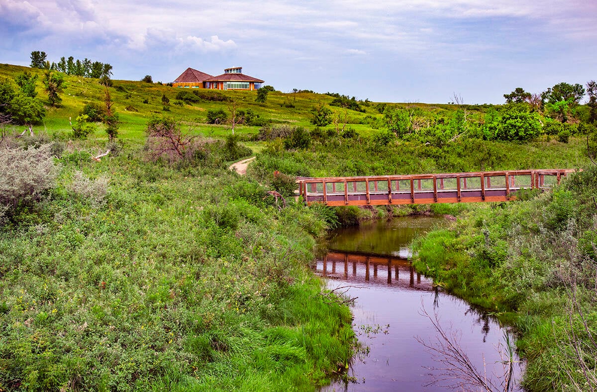 Opimihaw Creek, with a small bridge across it, in Wanuskewin Heritage Park.