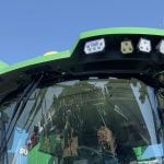 A man sits in the cab of a new John Deere combine on display at Canada's Outdoor Farm Show in Ontario in September, 2025.