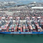 An aerial view of a Cosco shipping container cargo ship at the Port of Long Beach.