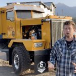Chace Barber, president of Edison Motors, stands beside one of the hybrid diesel-electric trucks built for a road maintenance contractor in British Columbia.