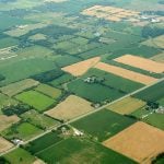 Higher farmland taxes for investors could solve two problems
