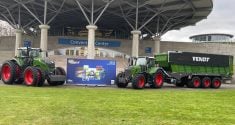 Two Fendt tractors are parked beside an "Agritechnica" sign on the grounds of the world's largest farm machinery show in 2023.