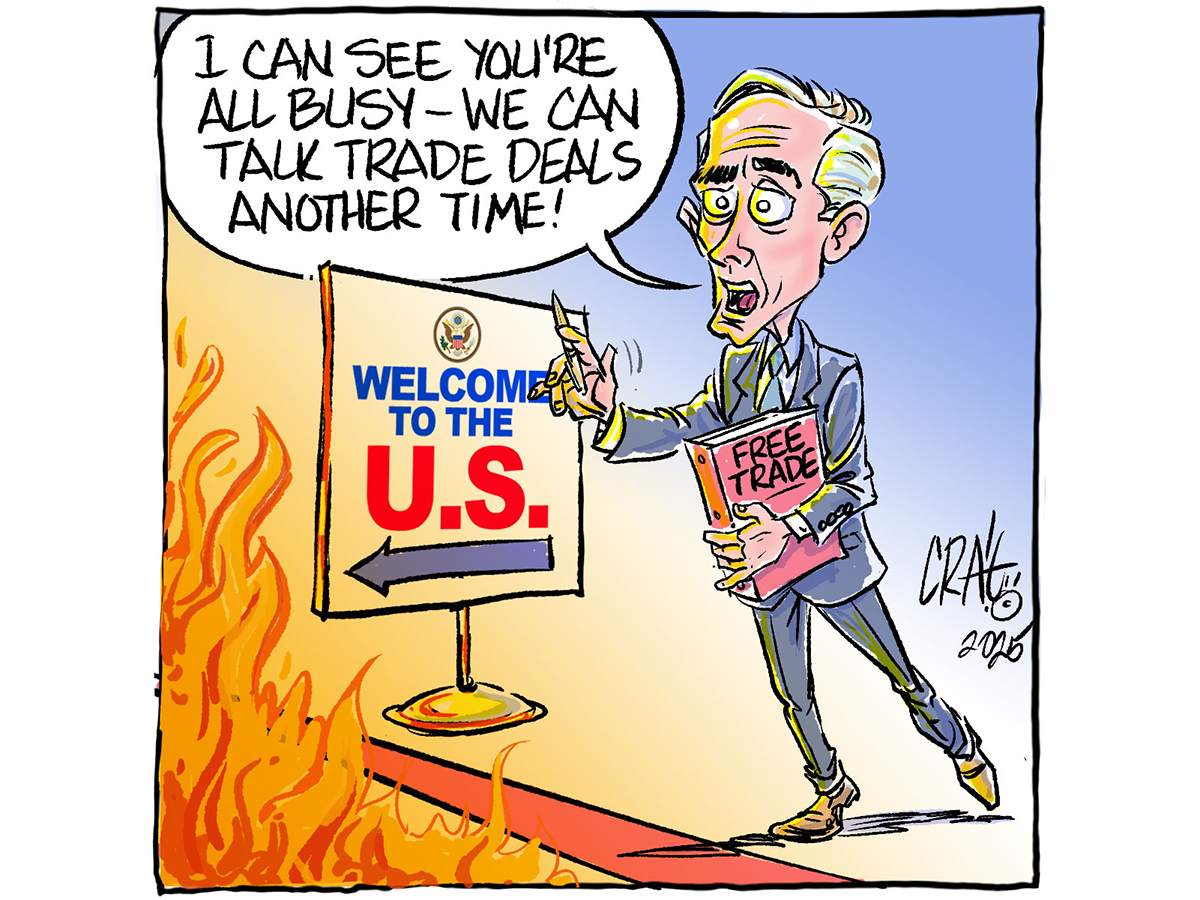 An editorial cartoon depicting Canadian Prime Minister Mark Carney, standing at a red line representing the Canada U.S. border, flames visible on the U.S. side of the border, and Carney is saying, "I can see you're all busy - we can talk trade deals another time!"