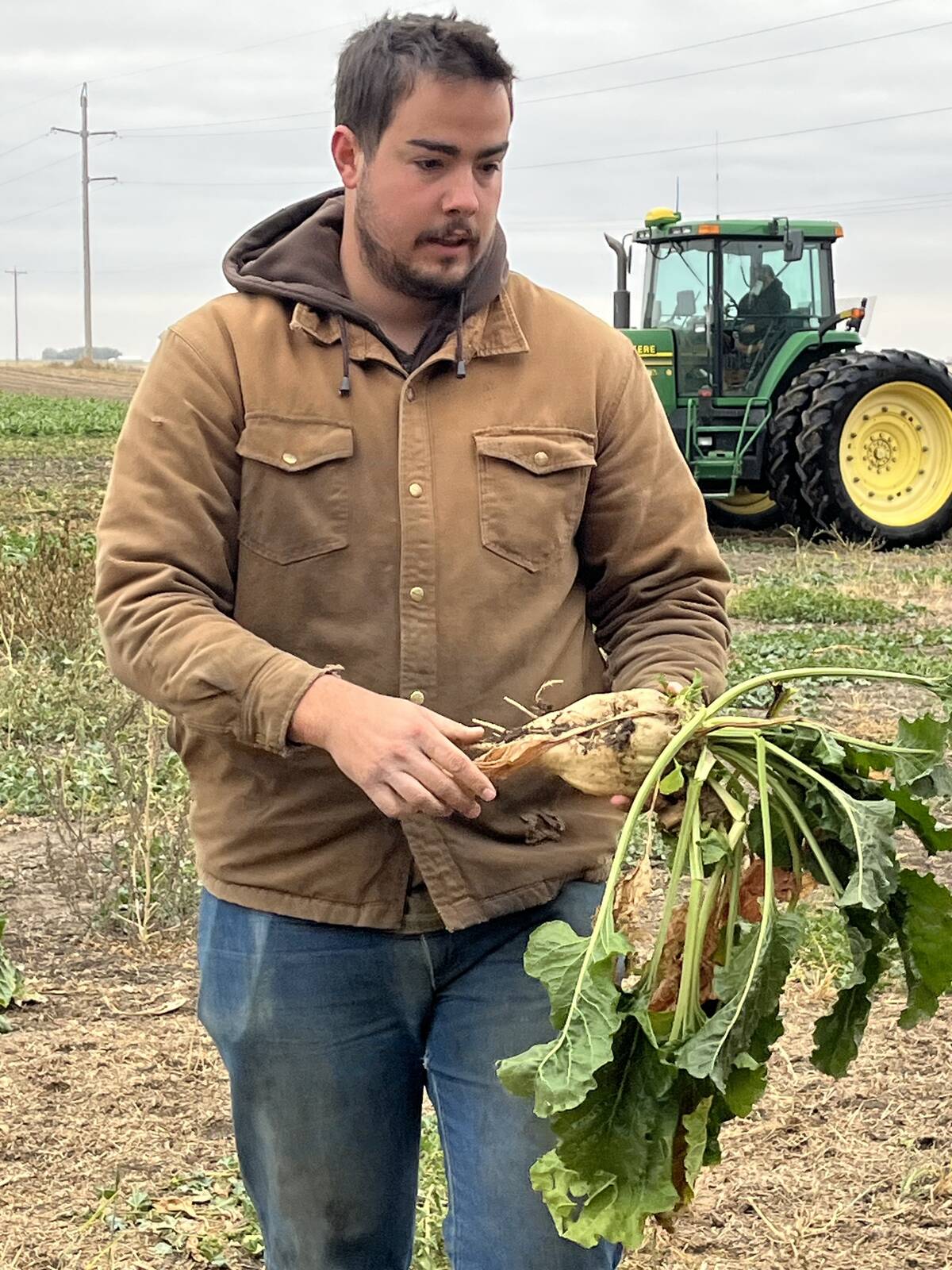 Ben Tokariuk holds a freshly-picked sugar beet on his family's farm near Coaldale, Alberta.