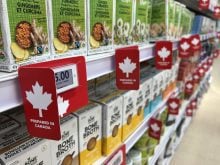 Labels show items prepared in Canada on shelves at a grocery store in Richmond Hill, Ontario, on October 25, 2025.