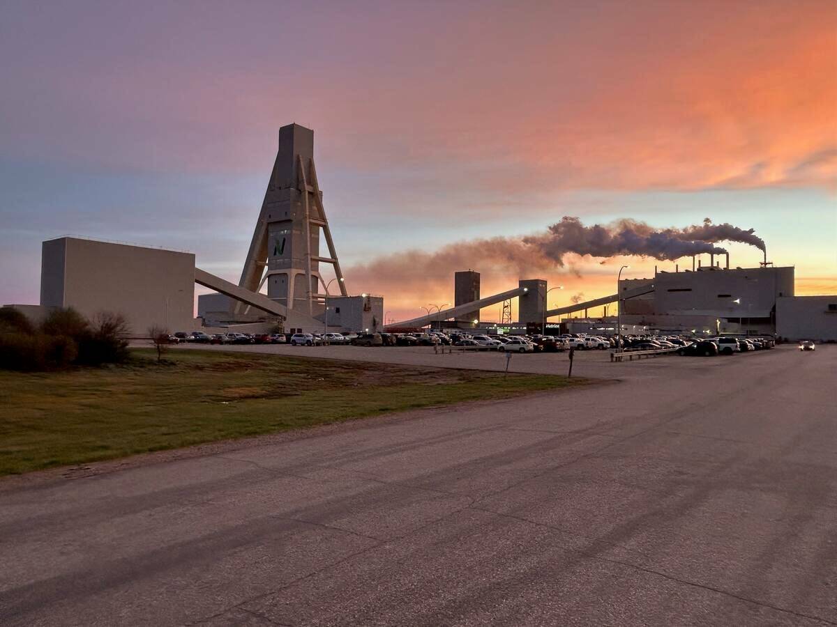 A Saskatchewan potash mine is silhouetted against the rising sun.