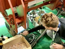 A Carbon Robotics&rsquo; team member sets up the LaserWeeder to burn small wood discs for a demonstration of the lasers at Agritechnica 2025.