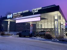 The exterior of the main entrance at Prairieland Park in Saskatoon featuring a large "Crop Production Show" LED sign.