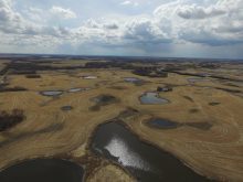 A photo taken by a drone showing the low areas on some land filled with water prior to drainage work being done.