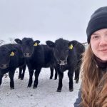 The Western Producer's new Farm Management Editor, Janelle Rudolph, poses in front of some curious calves on a snowy day.