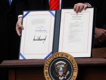 U.S. President Donald Trump shows off the United States-Mexico-Canada Trade Agreement (USMCA) after signing it on the South Lawn of the White House in Washington, U.S., January 29, 2020.