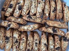 An overhead close-up of some biscotti on parchment paper.
