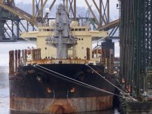 A grain ship sits awaiting its cargo at an idle grain terminal in the port of Vancouver.