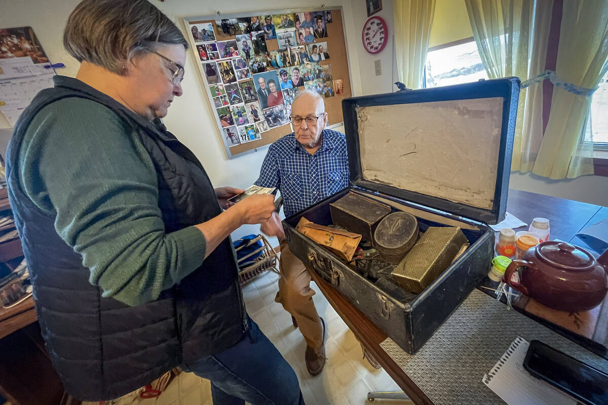 Diane Rourke and Dave Allinson look at a suitcase containing memorabilia.