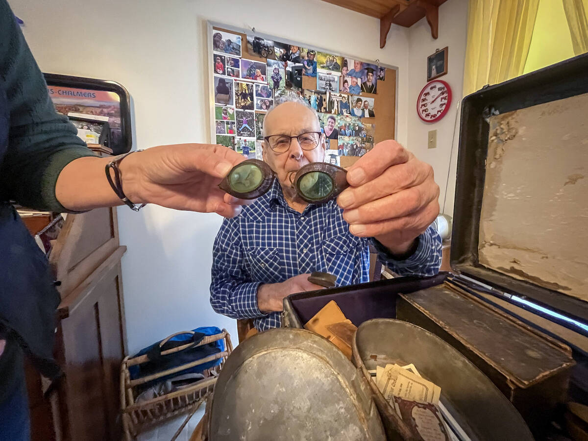 Diane Rourke and Dave Allison hold up a pair of old goggles found in a suitcase.