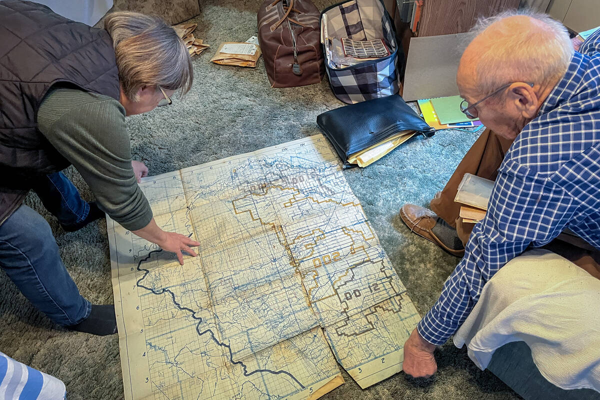 Diane Rourke and Dave Allison look at a drainage map found in an old suitcase.