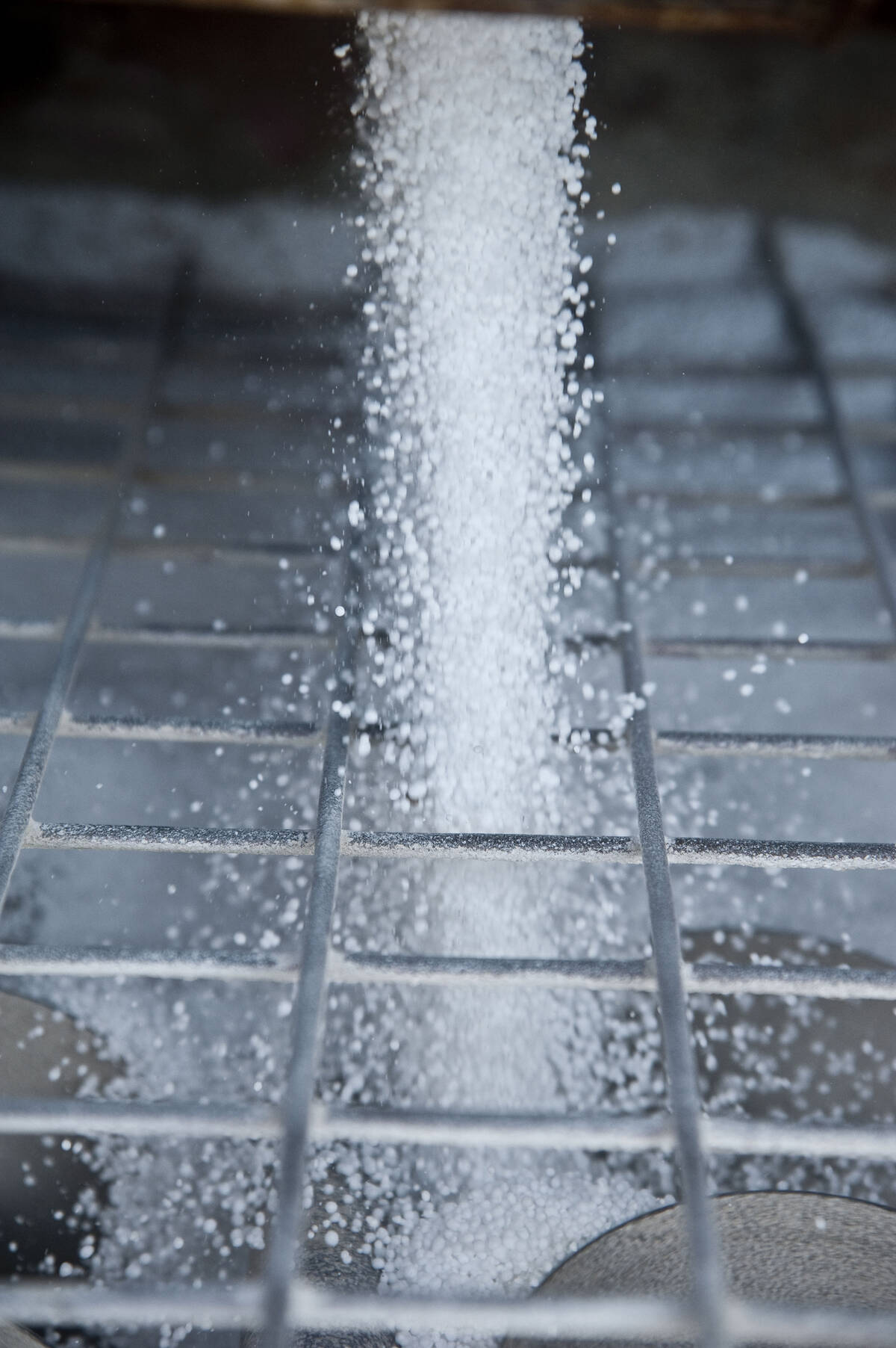 Urea fertilizer being poured though a screen.
