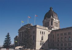 A photo of the front of the Saskatchewan Legislature against the backdrop of a clear blue sky.