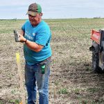 USask soil scientist Jeff Schoenau sets up soil sampling points in a field. He says variability in sampling is one reason soil test results can differ across methods and locations. Photo: Lynne Schoenau