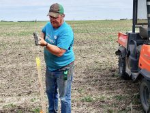 USask soil scientist Jeff Schoenau sets up soil sampling points in a field. He says variability in sampling is one reason soil test results can differ across methods and locations. Photo: Lynne Schoenau