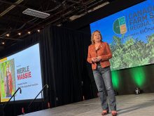 Merle Masse, executive director of DoMoreAg, speaks on stage at the recent Canada's Farm Show in Regina, Saskatchewan.