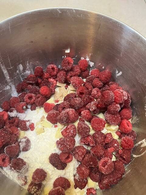 raspberries in melted chocolate in a pan on the stove