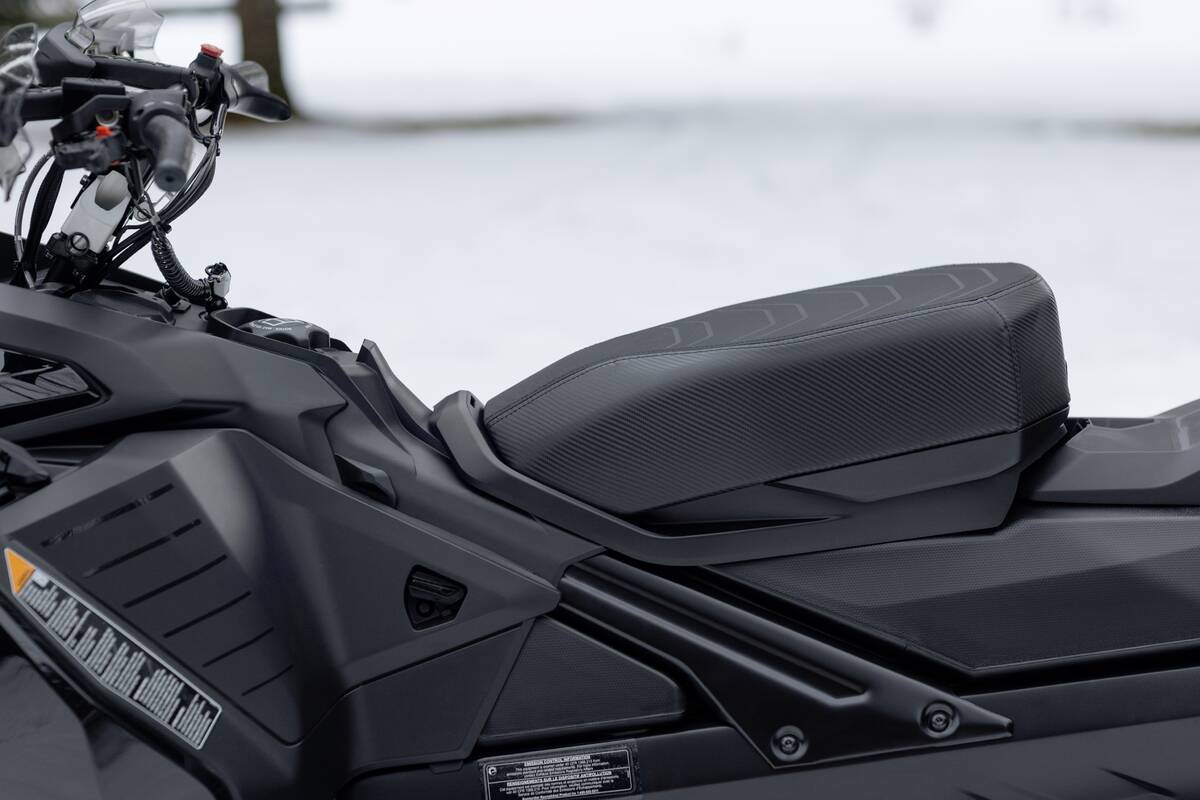 A close up of the REV body design's seat on a snow machine.