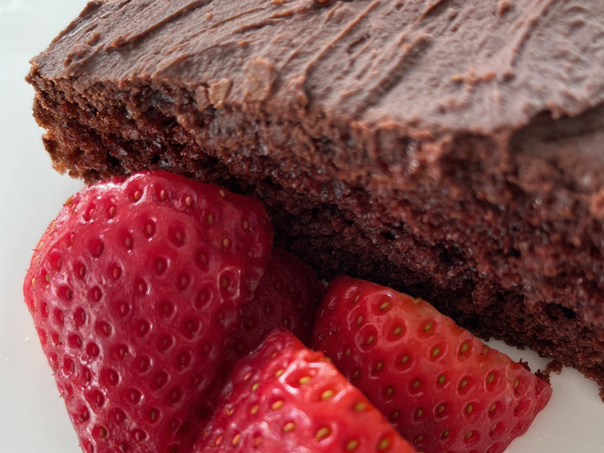 Chocolate cake with a side of strawberries.